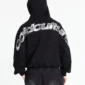 Vista trasera de la sudadera negra Cold Culture Tartan Curved Hoodie con capucha puesta y gráfico curvo de cuadros