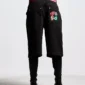 Modelo con shorts Badges Jorts de Cold Culture en Black Licorice, vista trasera de tres cuartos con parches gráficos