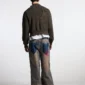 Modelo visto de espaldas con jersey negro Cold Culture Distress Curved Zip Knit de acabado desgastado