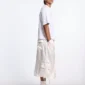 Vista lateral de modelo con Shorts Postal Capri de Cold Culture en color off-white y bolsillo cargo