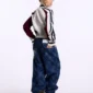 Modelo con pantalones Cold Culture Roll V2 en Raw Denim en vista trasera de tres cuartos, con bolsillos y logo bordado