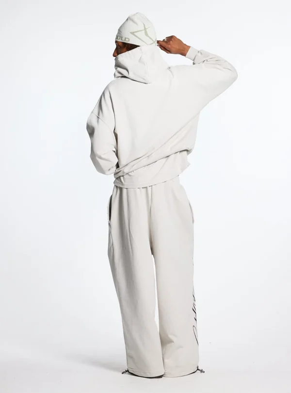 Modelo de espaldas con pantalones deportivos Cold Culture Script en gris claro y perneras de corte ancho