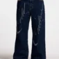 Vista frontal de los pantalones Cold Culture Script V3 en Raw Denim con corte de pernera ancha y gráficos desgastados