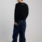Modelo con pantalones Cold Culture Script V3 en Raw Denim vistos por detrás, con gráfico de estrella en el bolsillo