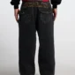 Detalle trasero de pantalones Cold Culture Studs en denim negro con bordado COLD y bolsillos cubiertos de tachuelas