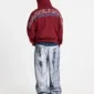 Vista trasera de un modelo con pantalones Waxed V2 de Cold Culture en denim lavado, con perneras amplias, bolsillos posteriores y acabado desgastado en azul y blanco.